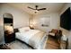 Modern bedroom featuring a comfortable bed, accent mirrors, and a flat-screen TV for a stylish retreat at 5686 Ellie Ct, Noblesville, IN 46062