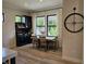 Dining room with large window overlooking a backyard with an elegant clock hanging at 5686 Ellie Ct, Noblesville, IN 46062