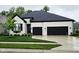 Charming home boasts a painted brick exterior, black trim, and a two-car garage at 5686 Ellie Ct, Noblesville, IN 46062
