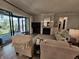 Cozy living room showcases backyard views and access, stone fireplace, and comfortable seating at 5686 Ellie Ct, Noblesville, IN 46062