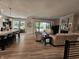 Inviting living room with a stone fireplace, large windows, and wood-look floors at 5686 Ellie Ct, Noblesville, IN 46062