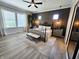 Bedroom with a large window, paneled accent wall, and neutral furniture at 5686 Ellie Ct, Noblesville, IN 46062