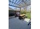 Outdoor kitchen with stainless steel appliances and bar seating underneath a pergola at 5686 Ellie Ct, Noblesville, IN 46062