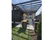 Outdoor kitchen includes a grill, prep area, and bar seating under a pergola overlooking the backyard at 5686 Ellie Ct, Noblesville, IN 46062
