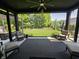 Covered patio with an outdoor ceiling fan and a view of a beautifully landscaped backyard at 5686 Ellie Ct, Noblesville, IN 46062