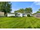 Expansive backyard with healthy green grass, partial privacy fence, and the rear of the house at 623 Circle Ct, Whiteland, IN 46184