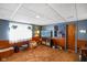 Finished basement with blue wallpaper and wood paneling, creating a cozy living space at 623 Circle Ct, Whiteland, IN 46184