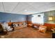 Finished basement living room with textured ceiling, comfortable seating, and ample room at 623 Circle Ct, Whiteland, IN 46184