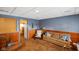 Basement living room featuring blue wallpaper and partial wood paneling with cozy seating at 623 Circle Ct, Whiteland, IN 46184