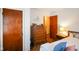 Comfortable bedroom featuring classic wood door and dresser, bathed in natural light at 623 Circle Ct, Whiteland, IN 46184
