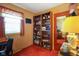 Cozy bedroom with natural light, a bookshelf, and warm-toned walls and carpet at 623 Circle Ct, Whiteland, IN 46184