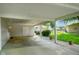 Covered carport offering protected parking and additional storage space with an open view to the lush backyard at 623 Circle Ct, Whiteland, IN 46184