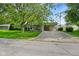 Charming single-story home featuring a well-manicured lawn, mature tree, and a convenient attached carport at 623 Circle Ct, Whiteland, IN 46184