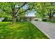 Well-maintained single-story home featuring a vibrant green lawn and mature trees offering ample shade at 623 Circle Ct, Whiteland, IN 46184