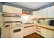 Close-up of the kitchen with vintage cabinets and tile countertops at 623 Circle Ct, Whiteland, IN 46184