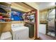 Functional laundry room area with washer, dryer, and organized storage shelving at 623 Circle Ct, Whiteland, IN 46184
