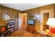 Vintage-style living room featuring wood paneling and display shelves with classic decor at 623 Circle Ct, Whiteland, IN 46184