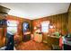 Retro living room with wood paneling, classic furnishings, and ample natural light at 623 Circle Ct, Whiteland, IN 46184