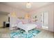 Pink bedroom with a matching pink bed set and a floral patterned rug on hardwood floors at 631 1St Nw Ave, Carmel, IN 46032