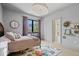 Neutral bedroom featuring a decorative flower wall decor and a colorful floral patterned rug on hardwood floors at 631 1St Nw Ave, Carmel, IN 46032