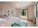 Bright pink bedroom featuring hardwood floors, a floral rug, a nice window view, and ample lighting at 631 1St Nw Ave, Carmel, IN 46032