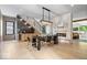 Elegant dining room with a modern chandelier, sleek fireplace, and a stylish staircase at 631 1St Nw Ave, Carmel, IN 46032