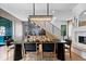 Dining room with elegant chandelier, dining table with seating, and wet bar beneath stairway at 631 1St Nw Ave, Carmel, IN 46032
