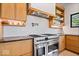 Close up of a stainless steel range and hood with custom cabinets and black countertops at 631 1St Nw Ave, Carmel, IN 46032