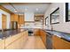 Spacious kitchen with an island, stainless steel appliances, black countertops and natural wood cabinets at 631 1St Nw Ave, Carmel, IN 46032