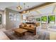 Spacious living room with a modern fireplace, wood beams, and an open design to the kitchen at 631 1St Nw Ave, Carmel, IN 46032