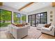 Bright living room featuring large windows, hardwood floors, and stylish white couches at 631 1St Nw Ave, Carmel, IN 46032