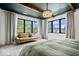 A spacious main bedroom featuring neutral colors, an attractive chandelier, and lots of natural light at 631 1St Nw Ave, Carmel, IN 46032