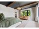 A bright main bedroom offers a relaxing spot by a window to sit and admire the natural light at 631 1St Nw Ave, Carmel, IN 46032