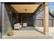 Inviting front porch with comfortable seating, wooden ceiling detail, and contemporary design elements at 631 1St Nw Ave, Carmel, IN 46032