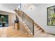 Staircase with black railing, hardwood floor and base, and window looking out to backyard at 631 1St Nw Ave, Carmel, IN 46032