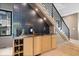 Stylish wet bar tucked beneath the stairs, complete with custom cabinetry and modern tile backsplash at 631 1St Nw Ave, Carmel, IN 46032
