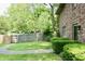 Lush backyard featuring a green lawn, mature trees, and a wooden privacy fence at 6519 Creekside Ln, Indianapolis, IN 46220