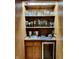 Wet bar with a sink, cabinetry, and wine refrigerator at 6519 Creekside Ln, Indianapolis, IN 46220