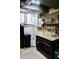 Functional basement workshop area with workbench, tool storage, and utility equipment at 6519 Creekside Ln, Indianapolis, IN 46220