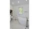 Bright, modern bathroom with a standalone tub and sleek fixtures, offering a spa-like experience at 6519 Creekside Ln, Indianapolis, IN 46220