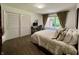 Relaxing bedroom features a large window with tan colored curtains and hardwood floors at 6519 Creekside Ln, Indianapolis, IN 46220