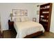 Inviting bedroom featuring a classic design, a warm color palette, and a full bookcase for storage at 6519 Creekside Ln, Indianapolis, IN 46220