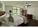 Bright bedroom featuring a high ceiling, a large window, and a bookshelf adding character to the space at 6519 Creekside Ln, Indianapolis, IN 46220