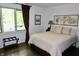 Cozy bedroom with a comfortable bed, natural light streaming through the window, and classic decor at 6519 Creekside Ln, Indianapolis, IN 46220