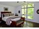 Bright bedroom with a large window, comfortable seating, hardwood floors and vaulted ceiling at 6519 Creekside Ln, Indianapolis, IN 46220