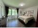 Cozy bedroom with a large window and dark hardwood floors at 6519 Creekside Ln, Indianapolis, IN 46220