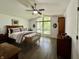 Spacious bedroom with a high ceiling, large windows overlooking trees, and a relaxing seating area at 6519 Creekside Ln, Indianapolis, IN 46220