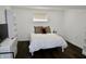 A cozy bedroom features a white color scheme, hardwood floors, and built-in shelves at 6519 Creekside Ln, Indianapolis, IN 46220