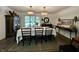 A sunlit dining room featuring a large window and seating for eight at 6519 Creekside Ln, Indianapolis, IN 46220