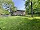 Charming brick home featuring lush green lawn and mature trees enhancing curb appeal at 6519 Creekside Ln, Indianapolis, IN 46220